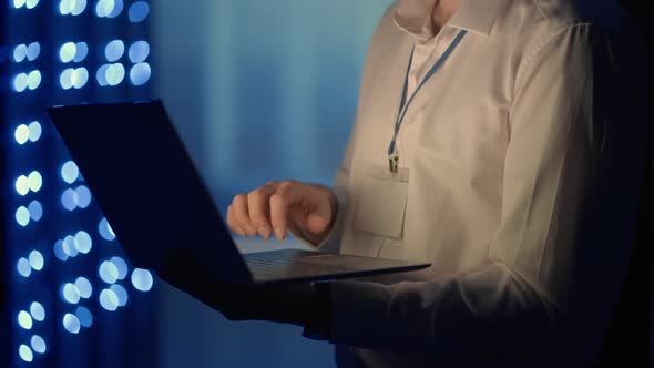 Face Portrait of Man Working in Server Room with Laptop