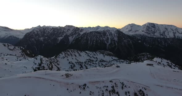 French alps at Chamrousse during early sunrise approaching the ridge, Aerial flyover shot