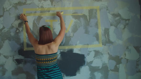 Young Adult Woman Choosing TV Screen Size with Stickers on the Wall, New TV Monitor Choice