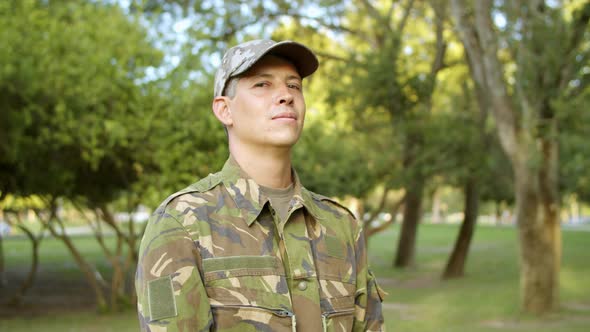 Portrait of Serious Man in Military Camouflage Uniform