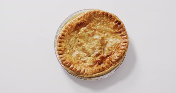 Video of pie seen from above on white background