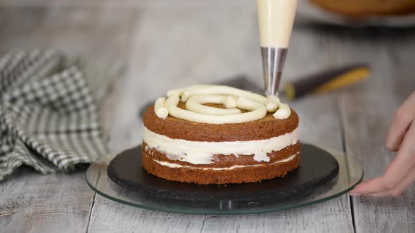 Pastry Chef's Hands Making Carrot Cake with Cream