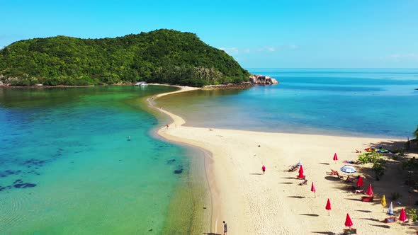 Beautiful drone tourism shot of a sunshine white sandy paradise beach and blue sea background 