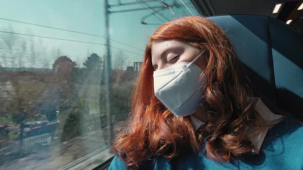Young Girl Sleeps on the Train with Ffp2 Mask While Traveling for Work