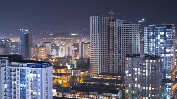 Multistorey Buildings with Changing Window Lighting At Night in City. Timelapse