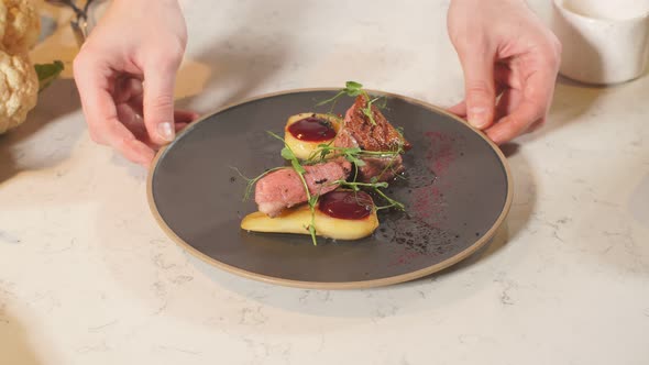 Male Chef Presents His Special Dish. He Stands in a Big Restaurant Kitchen