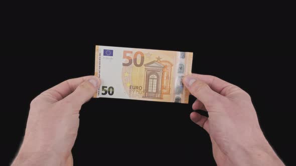 Male Hands Show a Banknote of 50 Euros with Alpha Channel