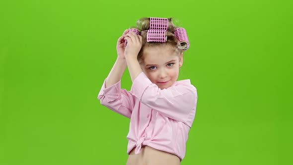 Child with Curlers on His Head, Removes Curlers. Green Screen. Slow Motion