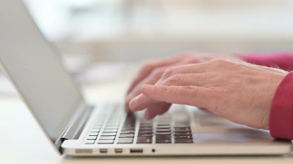 Hands of Old Man Typing on Laptop