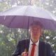Businessman Sheltering Underneath an Umbrella in the Rain - VideoHive Item for Sale
