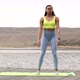 Athletic young woman fitness model warming up doing squats exercise for the buttocks. - VideoHive Item for Sale