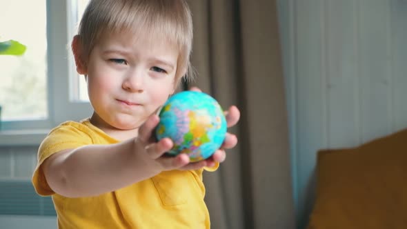 Child Boy with Blonde Hair Hugging Earth Globe Save Earth Concept