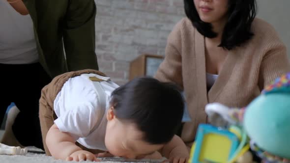 Asian baby child tries to get up and take the first step.