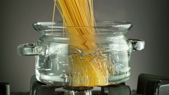 Super Slow Motion Shot of Fresh Spaghetti Falling Into Boiling Salted Water at 1000 Fps