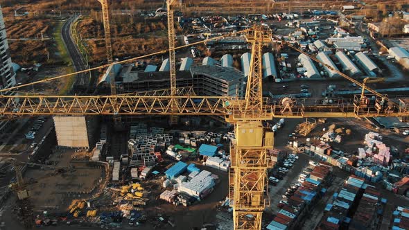 Close Aerial Motion at High Crane on Construction Site