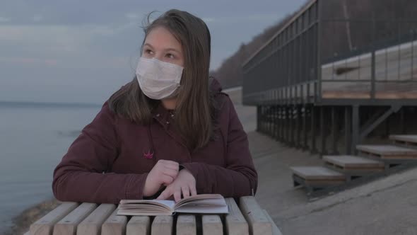 Young Girl in Black Mask Alone Outdoors. Coronavirus Pandemic