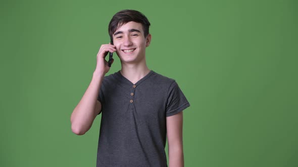 Young Handsome Iranian Teenage Boy Against Green Background