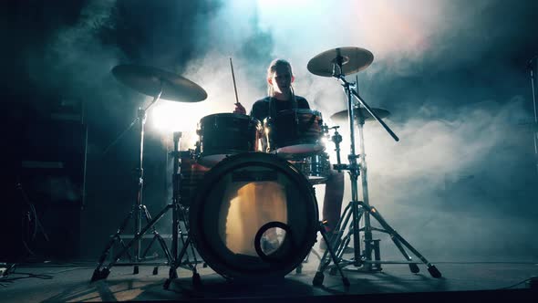 Musician Is Practicing with a Drum Kit in a Studio