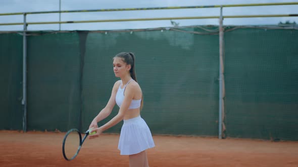 Outside on the Clay Court Female Tennis Player