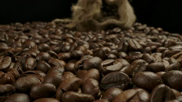 Low Point Macro View of Roasted Coffee Beans and Jute Sack