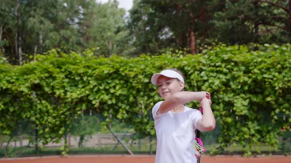 Young Girl Playing Tennis with a Partner