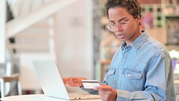 African Woman Having Online Payment Success on Laptop