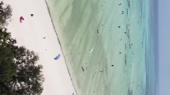 Vertical Video Kitesurfing Near the Shore of Zanzibar Tanzania Aerial View