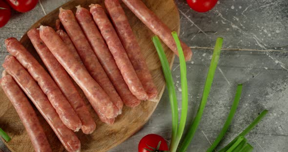 Raw Sausages with Green Onions and Tomatoes. 