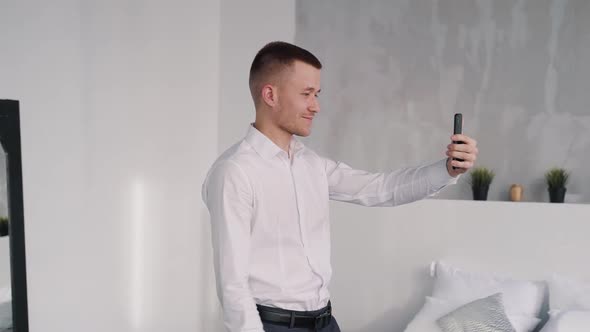 Independent Professional Looking Man in Suit Is Smiling and Talking By Phone Conference.