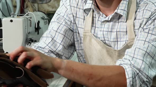 Male Shoemaker Polishing Shoes at His Workshop