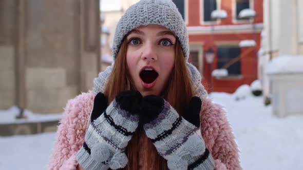 Excited Young Woman Looking to Camera Opening Her Mouth in Amazement Shouting Wow on City Street