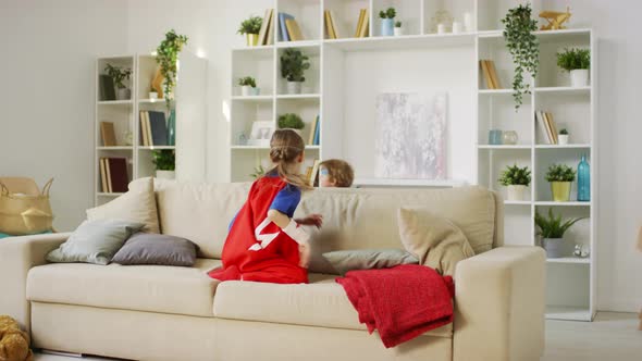 Superhero Children Playing Together on Sofa