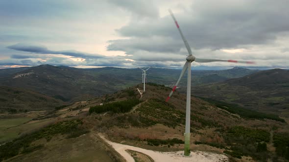 This is a video of a wind farm with multiple windmills, filmed near San Giovanni Lipioni in Italy. T