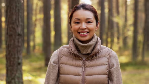 Happy Smiling Asian Young Woman in Forest