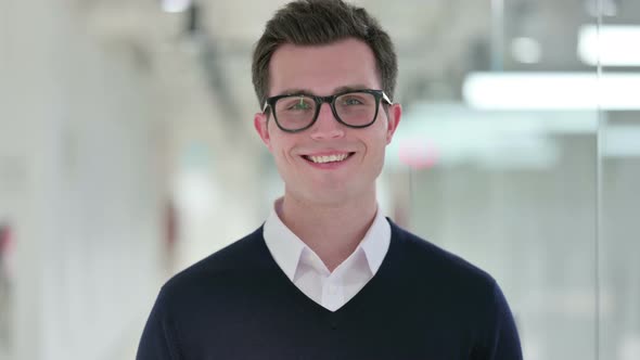 Smiling Young Businessman Looking at Camera 