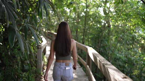 Young Fit Girl Walking On Jungle Path Sunny Slow Motion Shot