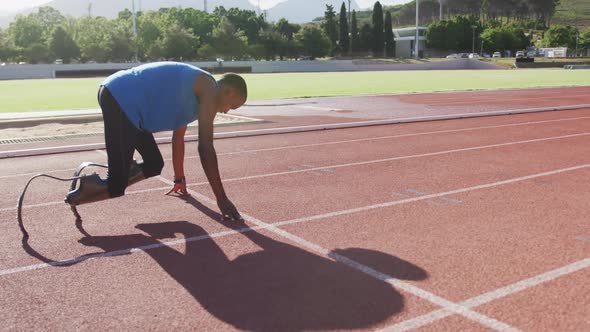 Disabled mixed race man with prosthetic legs starting a race