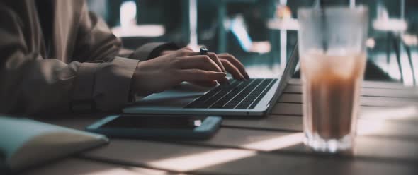 Young business woman typing and working on a laptop