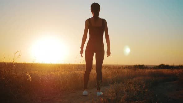 Young Fitness Sport Woman Running on Road at Sunset. Athlete Runner Feet Running on Road, Slow