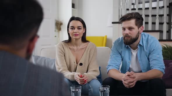 Young Couple Listening the Recommendations from Professional Male Psychologist