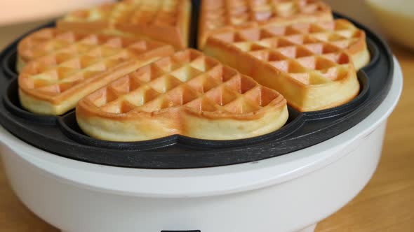 Flour Waffles on an Automatic Waffle Iron on the Table