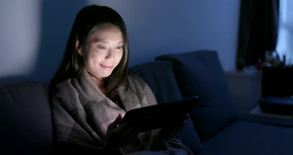 Asian woman use of tablet computer at home in the evening