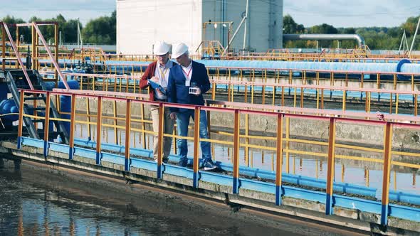 Two Businessmen Having a Discussion About a Biological Wastewater Treatment Plant