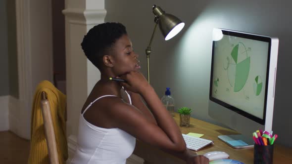 African american woman using computer while working from home