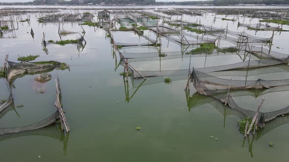 Aerial view of traditional floating fish pond on swamp in Indonesia