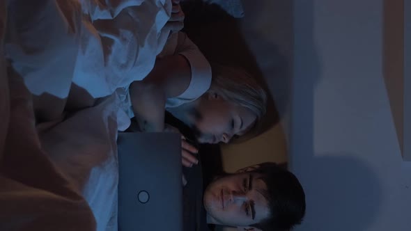 Night Online Shopping Couple Using Laptop Vertical