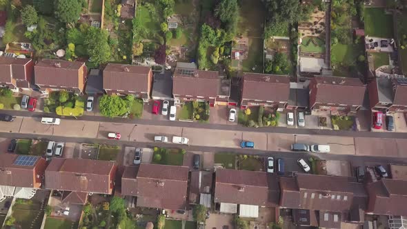 Wide Vertically Aerial shot of a British suburban Neighbourhood panning up to reveal the city of Exe