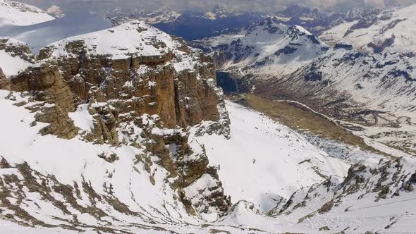 View of the snowy valley from the summit of Sass Pordoi in the Dolomites