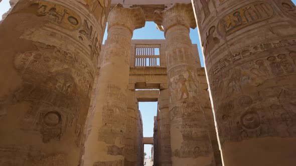 Camera Moves Between Majestic Columns with Ancient Egyptian Drawings