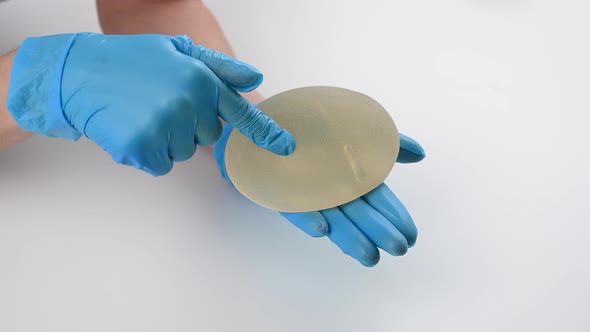 A Plastic Surgeon Shows a Breast Silicone Implant